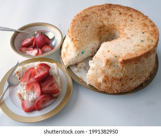 Angel Food Cake With Strawberries On Slice On Elegant Gold Rimmed Plate