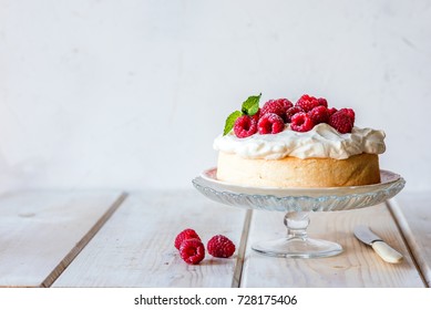 Angel food cake with whipped cream and fresh raspberries