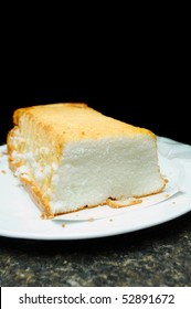 Angel Food Cake White Short Bread On A Countertop Isolated On Black Background Above With Room For You Text.