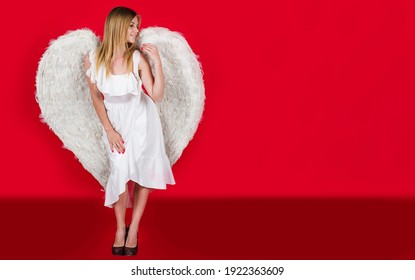 Angel girl in red. Woman with white wings. Valentines day cupid. Angels female. Valentine day.
