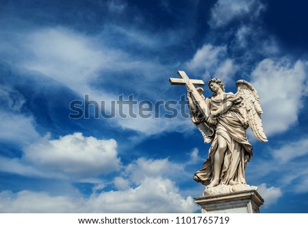 Angel holding the Holy Cross with heavenly sky and copy space. A 17th centuty baroque masterpiece at the top of Sant'Angelo Bridge in the center of Rome