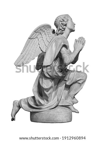 Angel statue isolated on white background. White stone sculpture of praying cherub