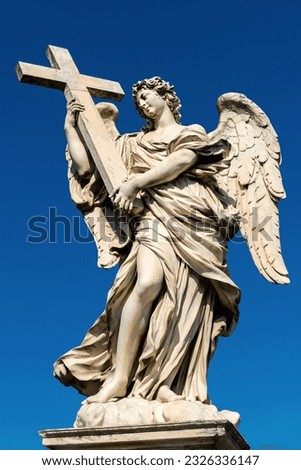 Angel statue on famous Ponte Sant’Angelo in summer, Rome, Italy. Beautiful old statue of winged woman with catholic cross. Vertical view of Renaissance statue on sky background in Roma city.
