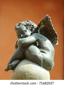 An Angel Statue Sitting On A Fountain