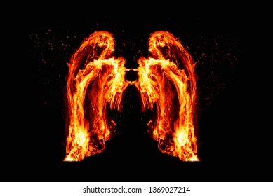Angelic Wings Made Of Real Fire With Black Background. Heavenly Wings Burning Bright With Embers