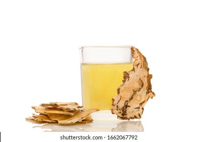 Angelica root slices and tincture isolated on white background. Medicinal plant, traditional chinese medicine.