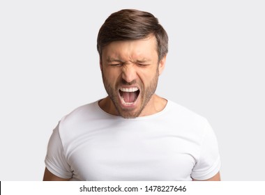 Anger Expression. Portrait Of Crazy Man Shouting Furiously Over White Studio Background. Copy Space - Shutterstock ID 1478227646