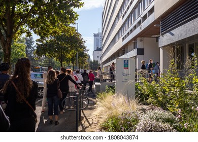 Angers, France - September 3 2020: People Wearing Face Protective Mask While Waiting In Line At The Social Security Office At France To Prevent Coronavirus, Concept Of Wearing Masks Outdoor Is