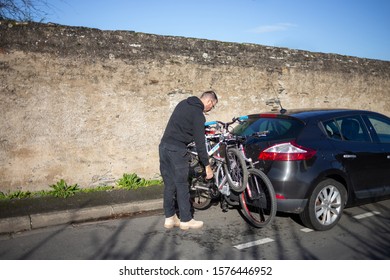 Angers, Maine Et Loire / France - November 29 2019: Mount For Two Bicycles On The Trunk Of A Car, Children And Adults Bike, Dad, Man