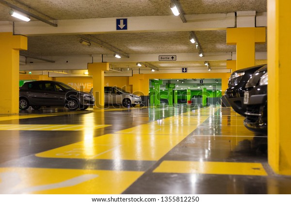 Angers, Maine et Loire / France - March 28 2019:\
underground parking in the shopping center. green and yellow color\
of the walls.