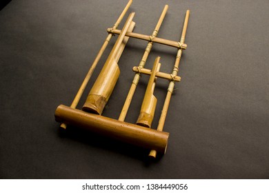 Angklung, the traditional sundanese musical instrument made from bamboo, isolated on black background - Shutterstock ID 1384449056