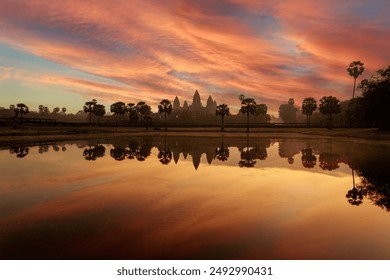 Angkor Wat temple at dramatic sunrise reflecting in lake Siem Reap, Cambodia - Powered by Shutterstock