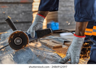 angle grinder, african american worker cutting metal outdoors - Powered by Shutterstock