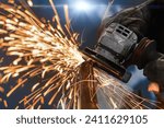 angle grinder, handyman worker using power tools grinding metal in a factory