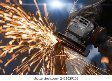 angle grinder, handyman worker using power tools grinding metal in a factory - Powered by Shutterstock