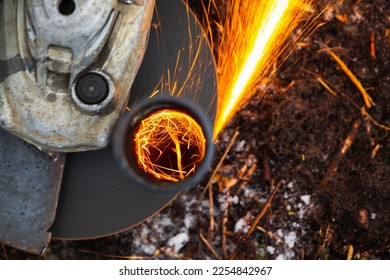 Angle grinder machine works with bright sparks stream, close up photo with selective focus - Shutterstock ID 2254842967