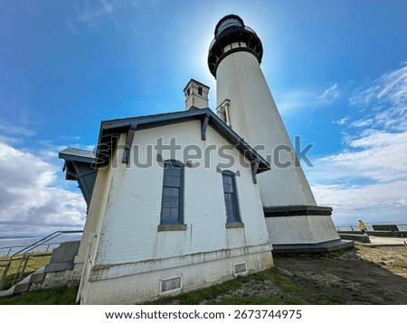 Angle looking up at Yaquina Head Lighthouse back lit by the sun, Newport, OR