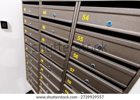Angle shows postal boxes with carrier confirming parcels