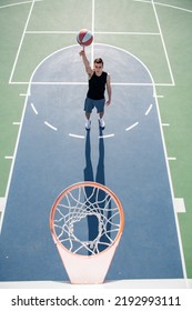 Angle View Of Man Playing Basketball, Above Hoop Of Man Shooting Basketball. Hand Spinning Basket Ball. Balancing Basketball On Finger.