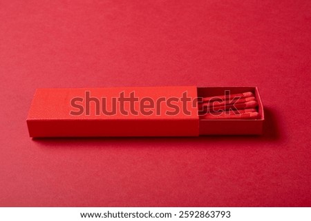 angle view red matchbox on a red background
