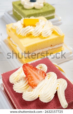 angle view three square cakes with different flavors at vertical composition
