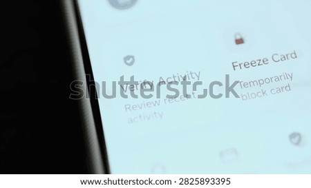 Angled close-up of a mobile banking security screen where verify recent activity before freezing suspicious payment card.