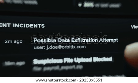 Angled close-up of a mobile cybersecurity screen where recent security incidents reveal possible data exfiltration.