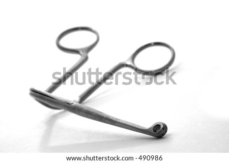 An angled forcep clamp (selective focus, tip is sharp, fades gently)