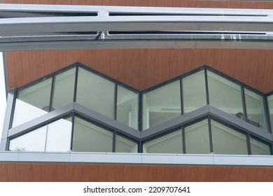 Angled Lines And Corners Of Glass Steel And Wood Conforming To The Two Story Tall Modern Bay Windows In A Downtown Urban Residential Commercial Building Unit