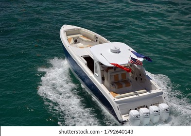 Angled Overhead View Of A High-end Luxury Speedboat Powered By Four Outboard Engines.