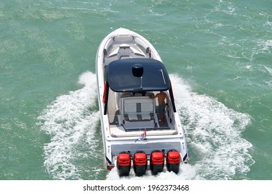 Angled Overhead View Of A High-end Motor Boat Powered By Four Outboard Engines.