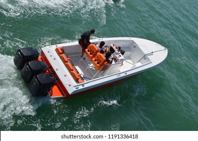 Angled Overhead View Of A Motor Boat Powered By Three Outboard Engines.