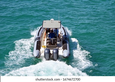 Angled Overhead View Of An Open Motorboat With Fiber Glass Canopy Powered By Two Outboard Engines.