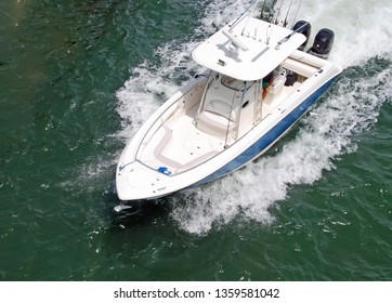 Angled Overhead View Of A Small Open Blue And White Fishing Boat