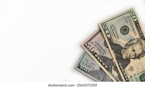Angled stack of US dollar bills including 20, 50, and 100 notes on a white background, suitable for financial, banking, or investment-related concepts. Ideal for advertising or business content.