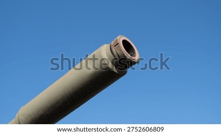 Angled Tank Barrel Muzzle Pointing Into Bright Sky, Visible Bore And Rim, Chipped Paint And Surface Wear, Field Engineer Maintenance Narrative, Outdoor Training Range Vibe