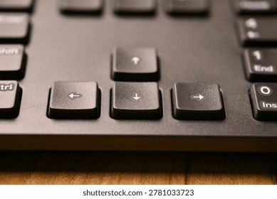 Angled Top View Macro Close-Up Black Keyboard Highlighting Down Arrow Key with Soft Blurred Tech Backgrounds