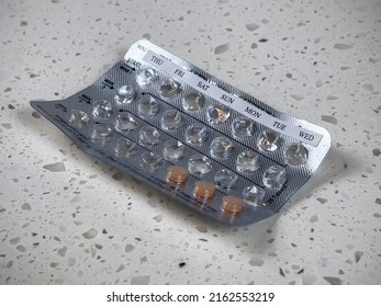 Angled View Of An Almost Empty Blister Pack Of Birth Control Pills On A White Counter Top