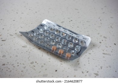 Angled View Of An Almost Empty Blister Pack Of Birth Control Pills On A White Counter Top