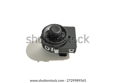 Angled view of a car mirror adjustment switch on white. Clean studio image highlighting automotive control design and functionality