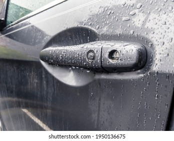 Angled View Of A Grey Car Door Handle, Covered In Rain Drops After A Storm In The Pacific Northwest