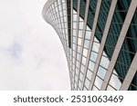 Angled view of modern skyscrapers in business district against blue sky. Looking Up high-rise office buildings.