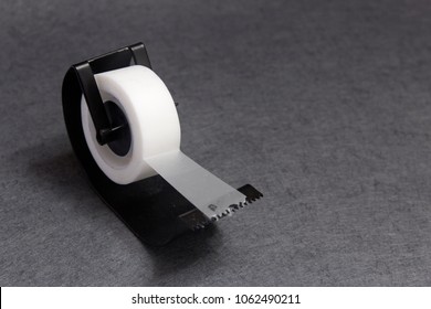 Angled View Of Sticky Tape Dispenser On Gray  Background