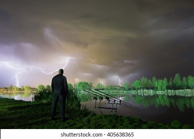 Angler patience. The storm is coming. Man standing in a storm. Man with cloud over his head. Night Fishing in a storm, Storm night fisherman. 
