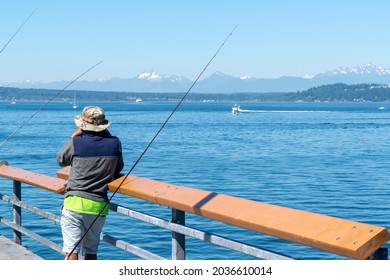 Anglers and boaters at Puget Sound on the coast of Edmonds, Washington have great views of the ocean and olympic mountains.