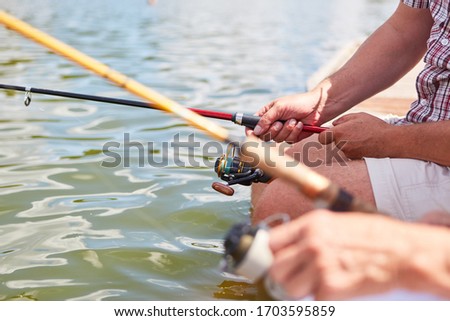 Anglers go fishing together on the lake in summer as a sign of patience and relaxation