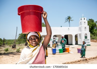Angoche District, Nampula/ Mozambique - 11.21.2015: Happy women with clean water from a recently installed water well at a Mosque in a poor village in Northeast Mozambique.