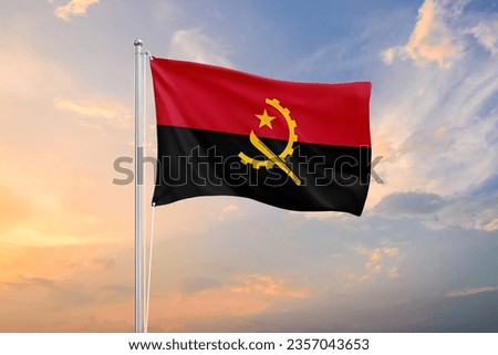Angola flag waving on sundown sky