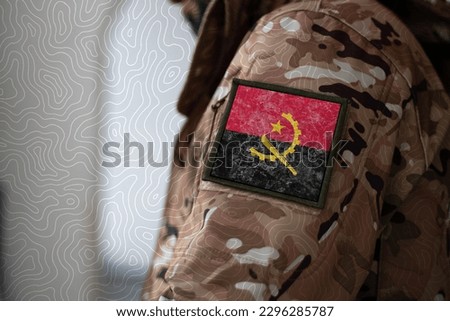 Angola Soldier. Soldier with flag Angola, Angola flag on a military uniform. Camouflage clothing