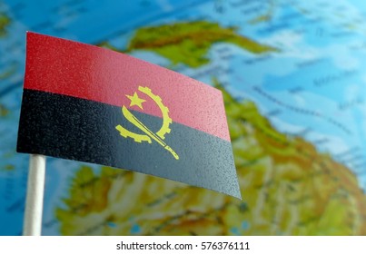 Angolan flag with a globe map as a background macro